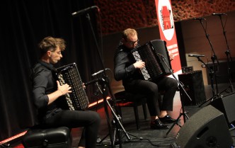 two men playing accordions