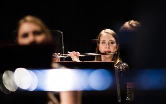 kobieta grająca na flecie na scenie Sali Koncertowej 