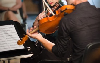 the woman and the man play the violin