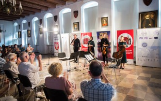 the musicians stand in front of the audience