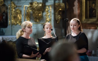 three girls are singing into the microphone