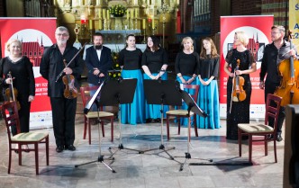 musicians are standing waiting for the applause