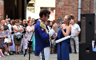 conductor and a woman singing into the microphone