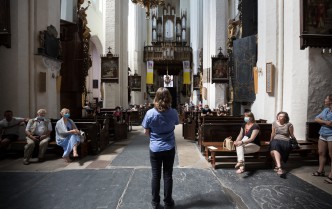 the man is standing with his back and talking to the audience