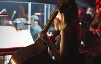 a woman holding a contrabass