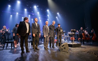 five men standing in a row on the stage