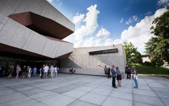 people standing in the square in front of the building