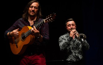 man playing guitar and man playing trumpet