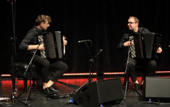 two men playing accordions