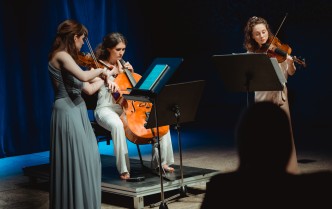 trzy kobiety grające na instrumentach smyczkowych