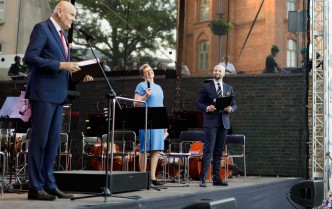 Three people standing on stage