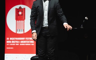 mężczyzna stojacy obok fortepianu