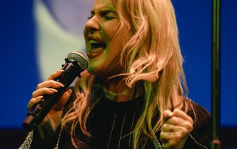 portret kobiety śpiewającej do mikrofonu