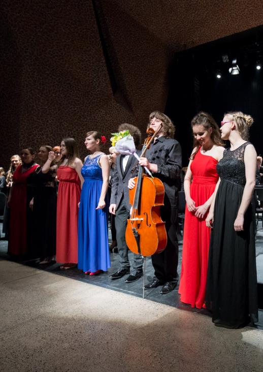 young people in elegant costumes standing in a row