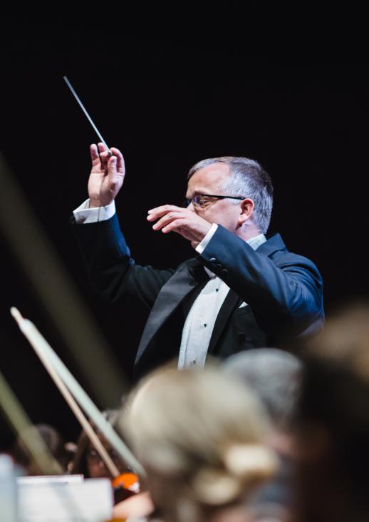 a man with his hands up and a baton in one hand