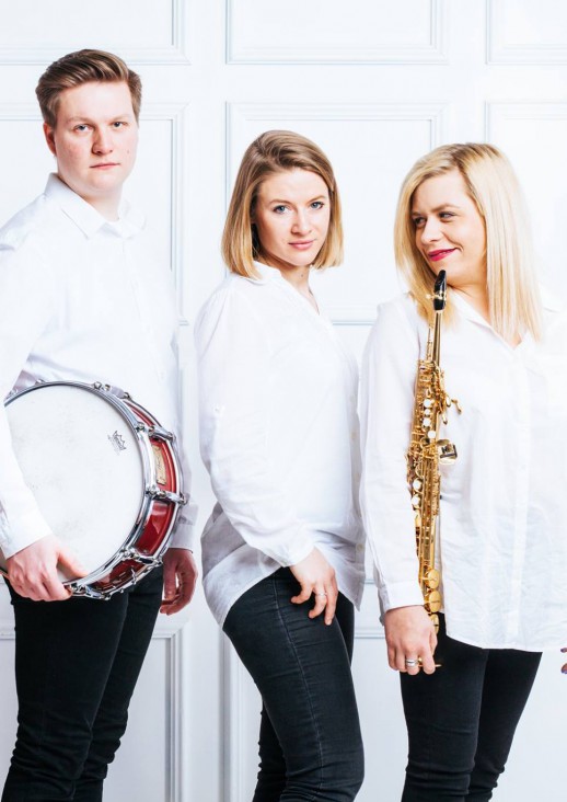 five people - a woman in a red dress, a man and a woman holding saxophones, a man holding a snare drum