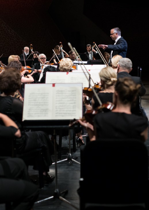 Musicians playing string instruments from notes placed on stands