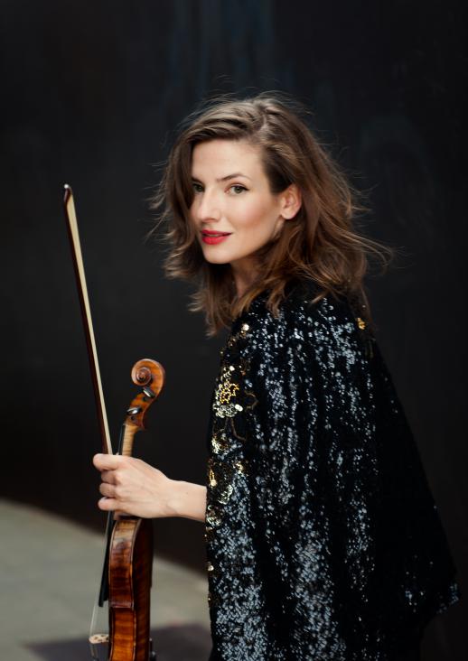 young woman holding a violin in her hand