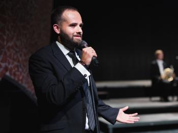 Man in suit on stage