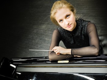 woman leaning on the piano